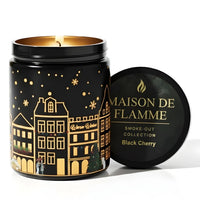 Thumbnail for Maison de Flamme Black Cherry light-up scented candle in black jar with winter village artwork and gold lid – Smoke-Out Collection, available at Shopeezy.