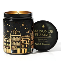 Thumbnail for Maison de Flamme Apple & Cinnamon light-up scented candle in black jar with winter village artwork and gold lid – Smoke-Out Collection, available at Shopeezy.