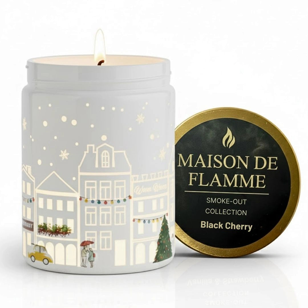 Maison de Flamme Black Cherry light-up scented candle in white jar with winter village artwork and gold lid – Smoke-Out Collection, available at Shopeezy.