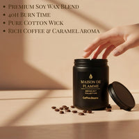 Thumbnail for Hand reaching for the black Coffee Beans scented candle on a table with coffee beans — warm roasted coffee home fragrance