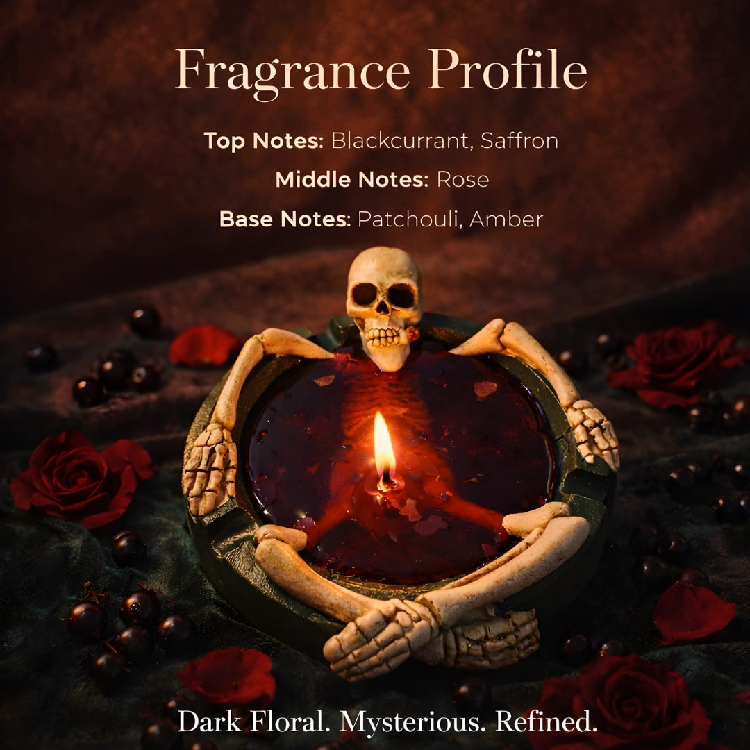 Skeleton novelty candle with blackcurrant, saffron, rose, patchouli and amber fragrance notes displayed, dark floral Halloween scented candle in red wax skull holder