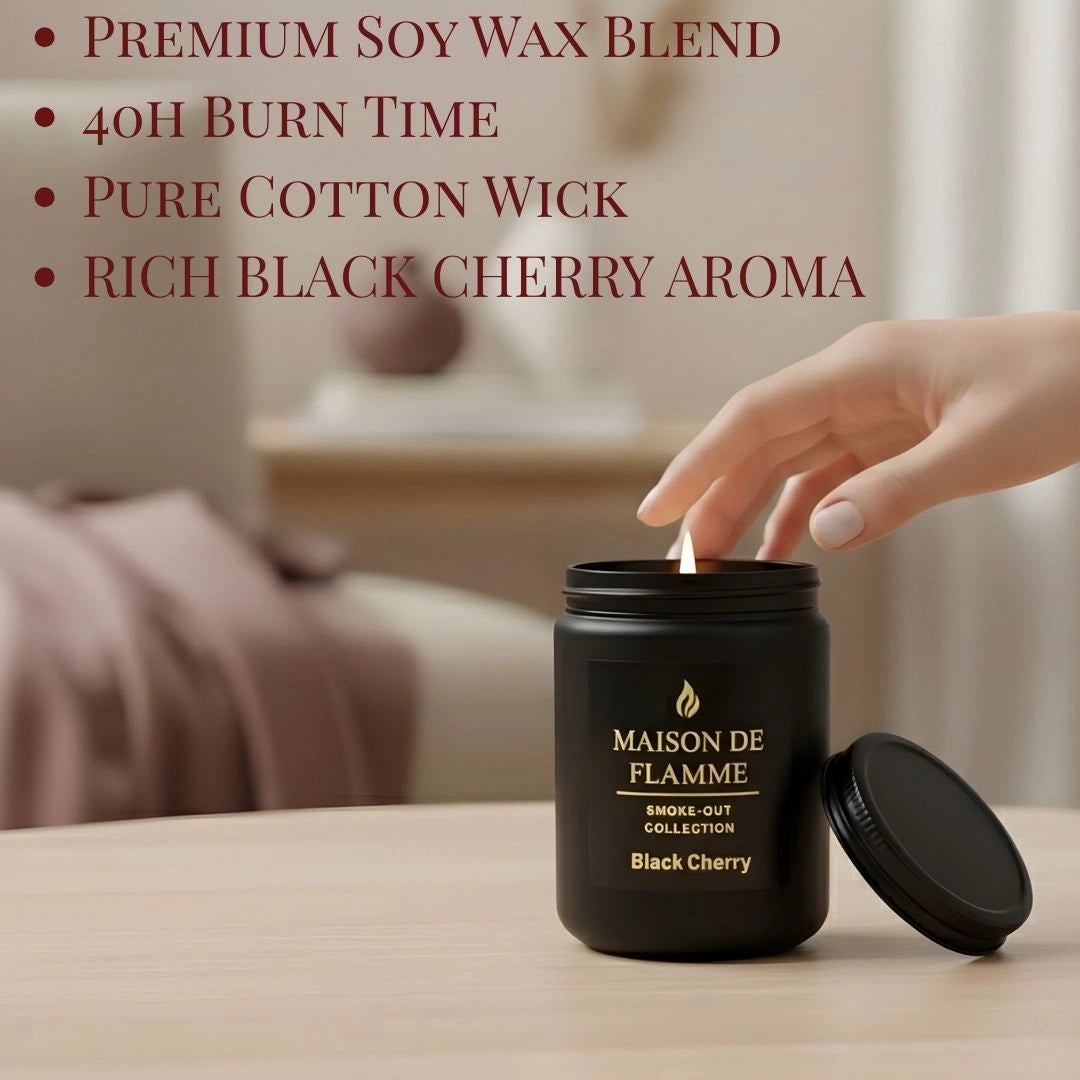 Hand reaching for the black Black Cherry candle on a modern table — fruity deep cherry home fragrance.