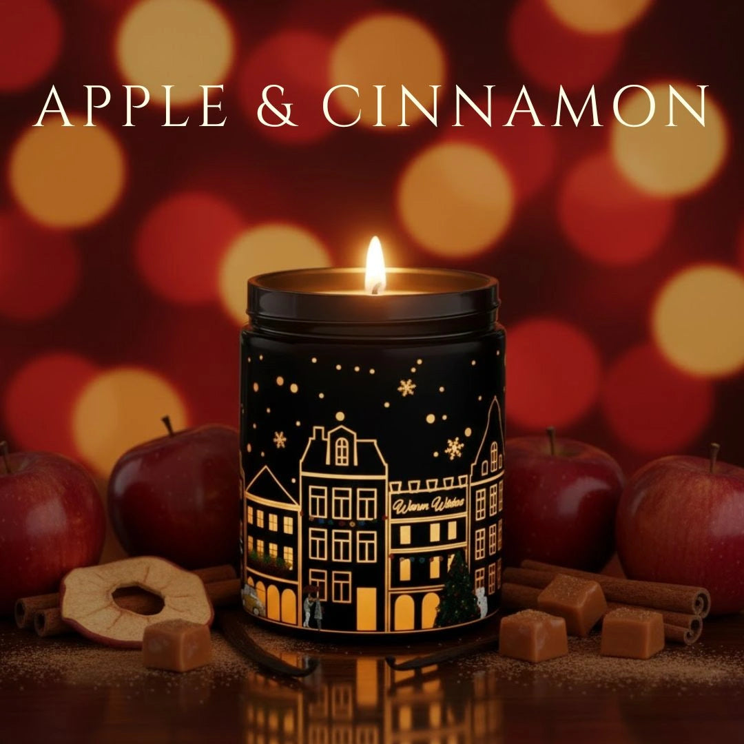 Apple & Cinnamon candle in a black jar glowing with apples, cinnamon sticks, and festive ingredients in a warm holiday setting, available at Shopeezy.