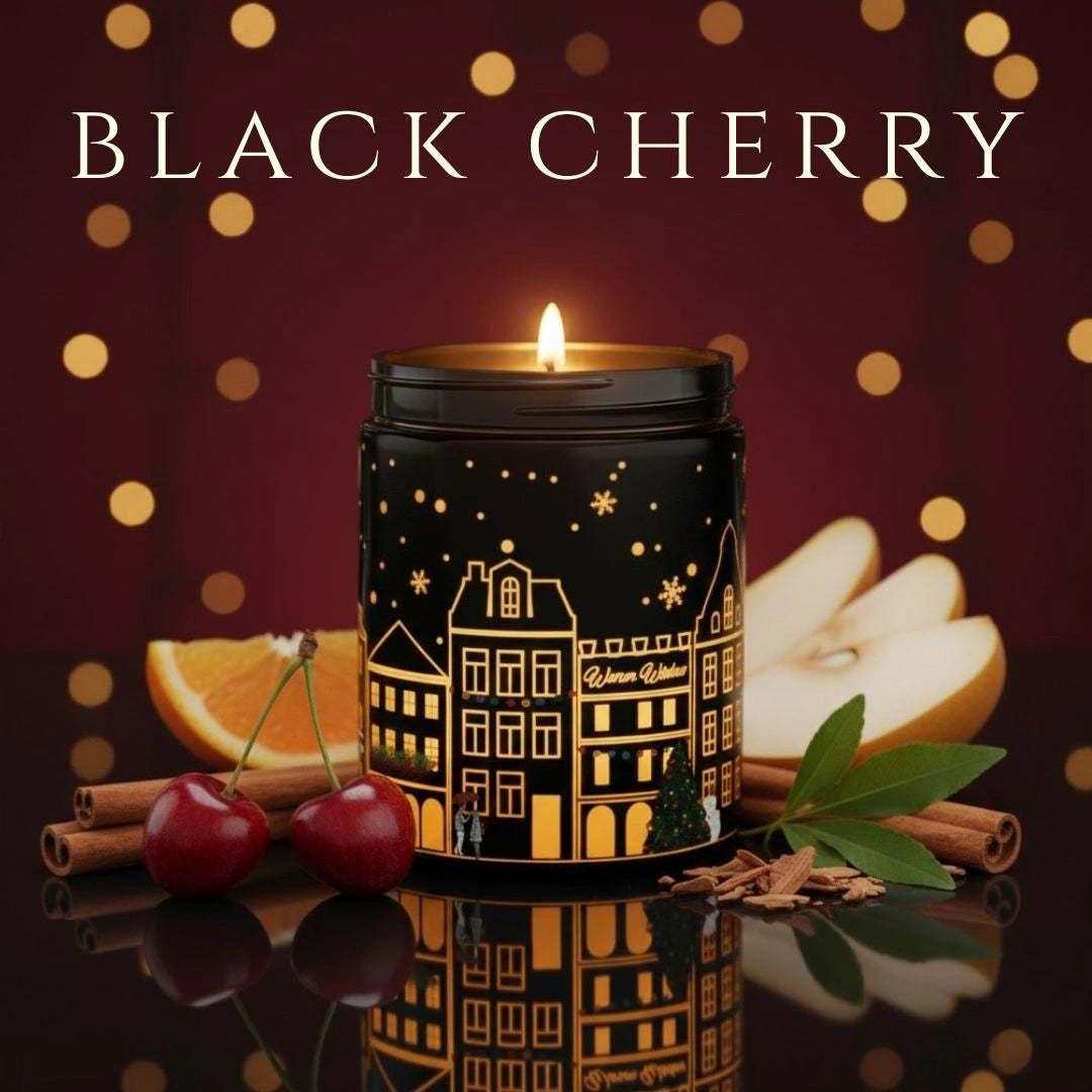 Black Cherry scented black candle glowing with cherries, pears, and cinnamon props – warm fruity holiday aroma, available at Shopeezy.