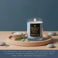 Thumbnail for Sea Salt & Sage candle on wooden grain board with pebbles and sage, calm coastal home fragrance.
