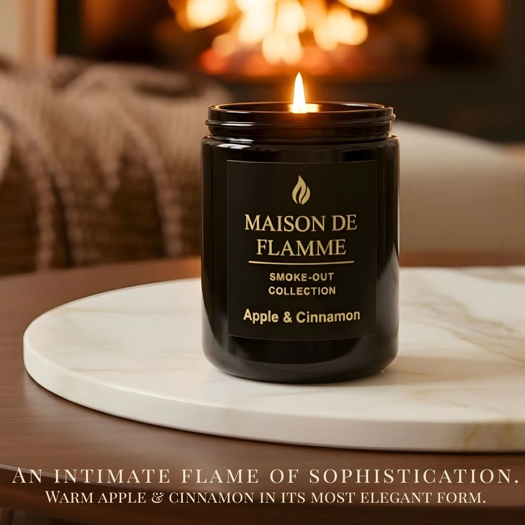Maison De Flamme Apple & Cinnamon candle in black jar styled near fireplace — warm comforting apple spice aroma.