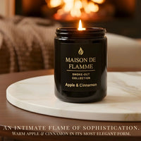 Thumbnail for Maison De Flamme Apple & Cinnamon candle in black jar styled near fireplace — warm comforting apple spice aroma.