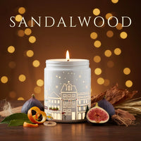 Thumbnail for Sandalwood candle glowing with figs, cedarwood, and warm festive décor – rich earthy fragrance, available at Shopeezy.