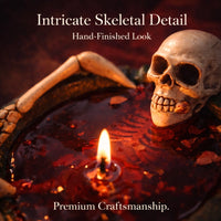 Thumbnail for Close up of skeleton arms and skull detail holding red wax candle, premium craftsmanship Halloween novelty candle with realistic bone design