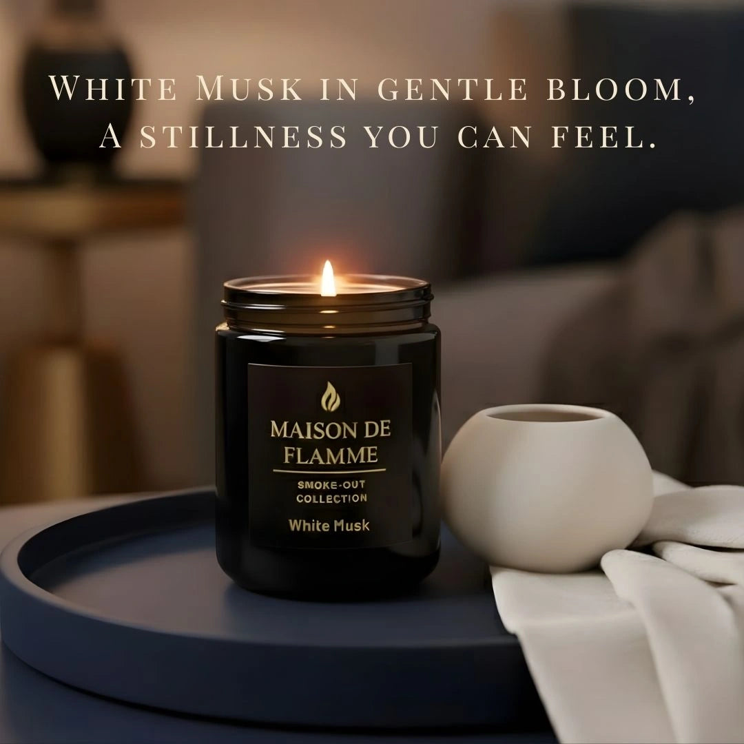 Black White Musk scented candle lit in a cozy home setting — warm clean musk aroma with soft ambient lighting.