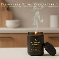 Thumbnail for Vanilla & Coconut scented candle in black jar on a kitchen counter — odor-eliminating warm vanilla and coconut aroma.